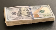 A stack of cash is seen in this file photo. (Ed Pevos | MLive.com file)