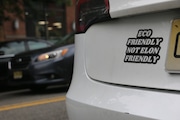 An "Eco Friendly Not Elon Friendly" bumper sticker on a vehicle in Jersey City, NJ, on May 16, 2025. Drivers around the state have added similar stickers to their Teslas amid political criticism levied against President Donald Trump and Elon Musk.