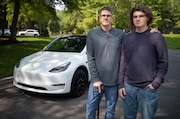 James Keefer, left, and his son Lochlan Keefer stand in front of their family Tesla in Cherry Hill, NJ on Thursday, June 12, 2025. An instructor failed Lochlan on his road test after accusing him of using driving assist features on the Tesla.