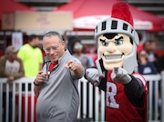 Outgoing Rutgers President Jonathan Holloway (left) poses with Sir Henry, the Scarlet Knights mascot, during halftime of the Scarlet-White spring game, Saturday, April 26, 2025 in Piscataway, N.J.