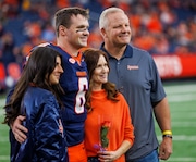 Quarterback Kyle McCord is honored on Senior Day before the Syracuse Orange clashed with the University of Connecticut Huskies at the JMA Wireless Dome on Saturday, Nov. 23, 2024. Pictured here with McCord, from left, are McCord's girlfriend Sophia Giangiordano; mother, Stacy McCord; and father Derek McCord (N. Scott Trimble | strimble@syracuse.com)