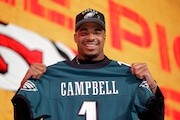 Alabama linebacker Jihaad Campbell poses with a jersey after being chosen by the Philadelphia Eagles in the first round of the NFL Draft on April 24, 2025, in Green Bay, Wis.