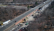 Work crews and equipment cover the eastbound lanes of Route 80 in Wharton as an effort to repair a sink hole continues. The latest sinkhole showed up as a depression in the center lane on Feb. 10, which later fell in. Since then, DOT crews have been conducting continued testing to find underground voids, drill and fill them with grout. Wharton, N.J. March 19, 2025