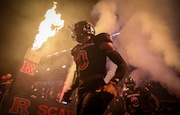 Amidst a sea of fire and pyrotechnics, Rutgers defensive back Eric Rogers (0) and the rest of the Scarlet Knights emerge from the tunnel to play Washington, Friday, Sept. 27 2024, in Piscataway, N.J.